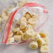 The frozen bananas are spilling out of a ziploc bag.