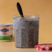 A spoon is in the jar with the chia seed pudding with yogurt.
