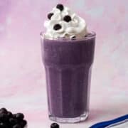 The blueberry milkshake is topped with whipped cream and dotted with blueberries.