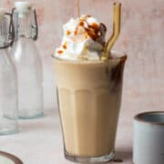 Caramel is being poured over the caramel milkshake.