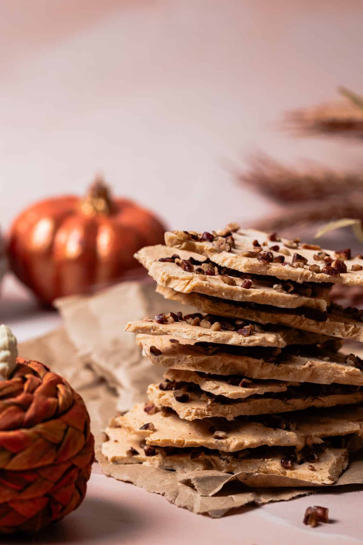 Pumpkin spice yogurt bark is cut into pieces and stacked on top of each other.