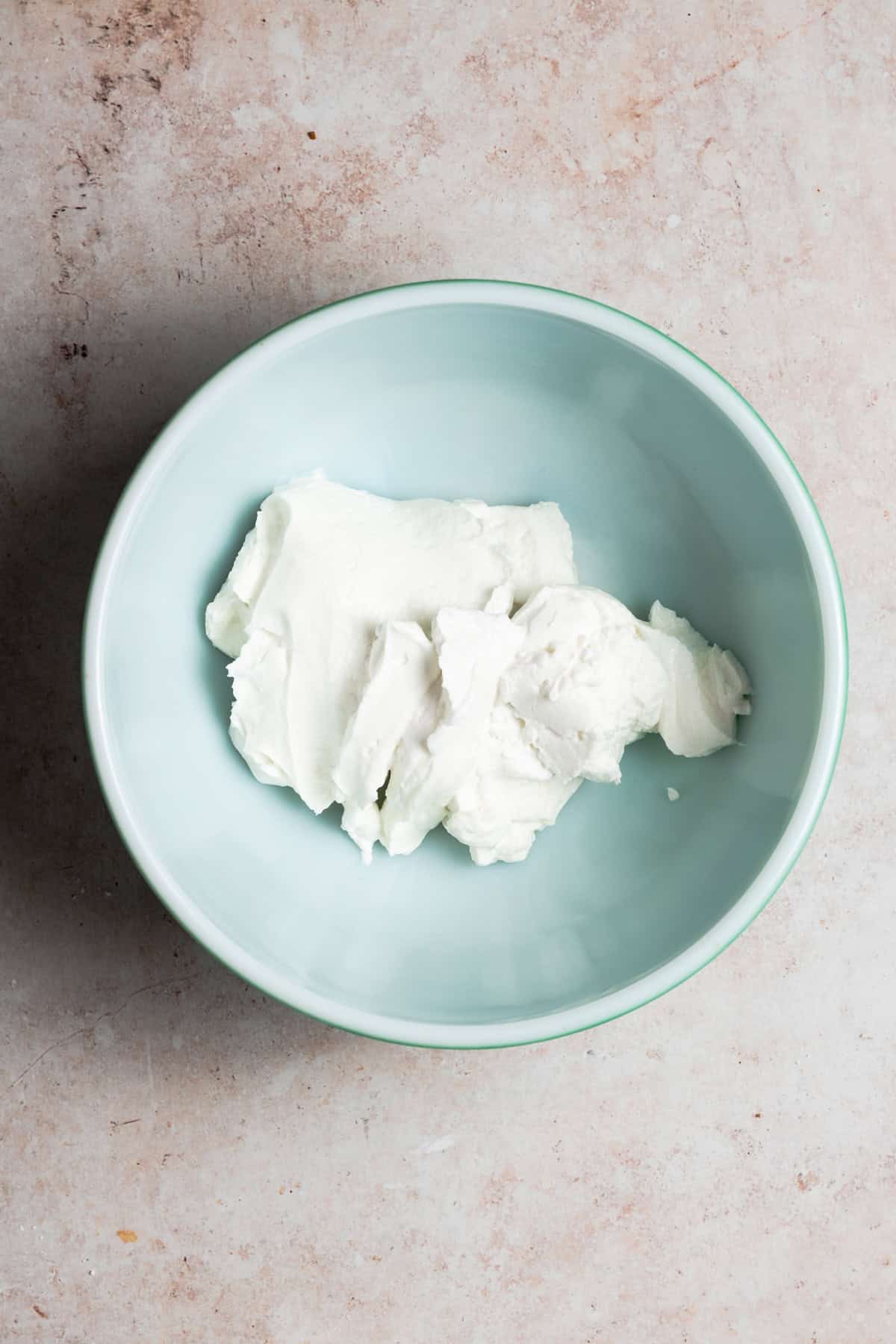 The yogurt is in a teal bowl.