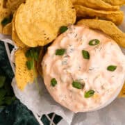 Scallions are sprinkled on top of the bowl with the Mexicali dip.