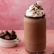The old fashioned chocolate milkshake is topped with homemade whipped cream and chocolate shavings.