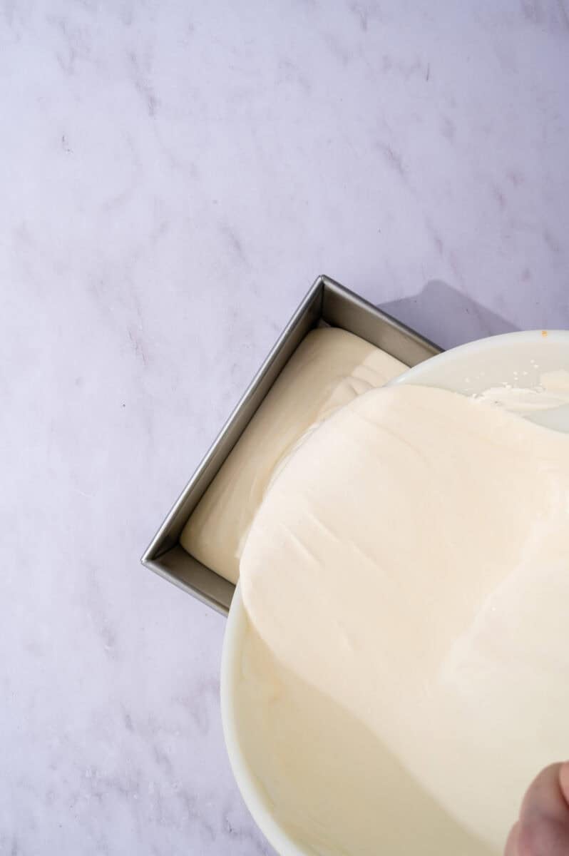 The vanilla ice cream is added to the loaf pan.