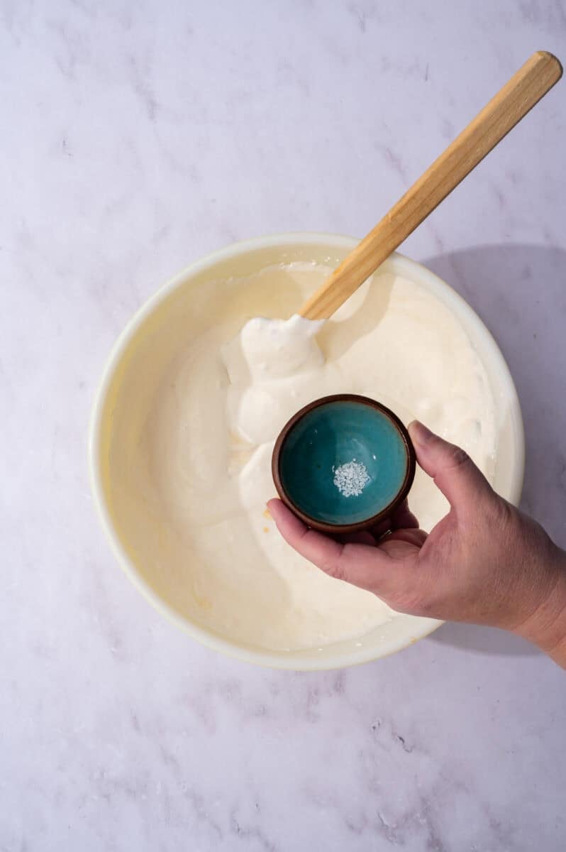 The salt is added to the large mixing bowl.