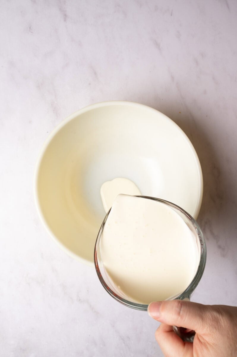 The heavy cream is added to a bowl.