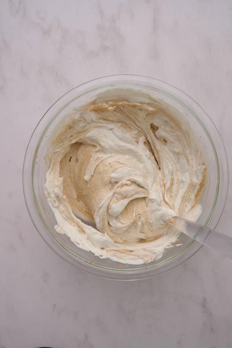 The whipped topping is added to the bowl.