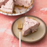 A fork is on a plate with the no bake cranberry cream pie.