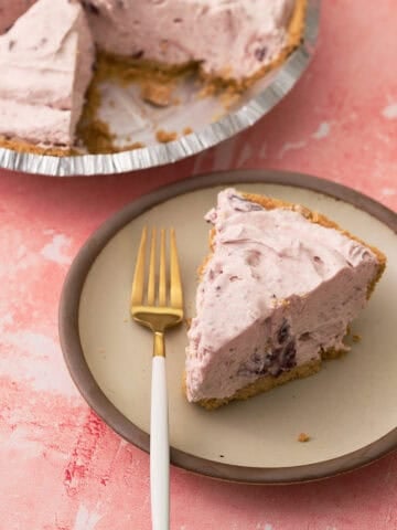 A fork is on a plate with the no bake cranberry cream pie.