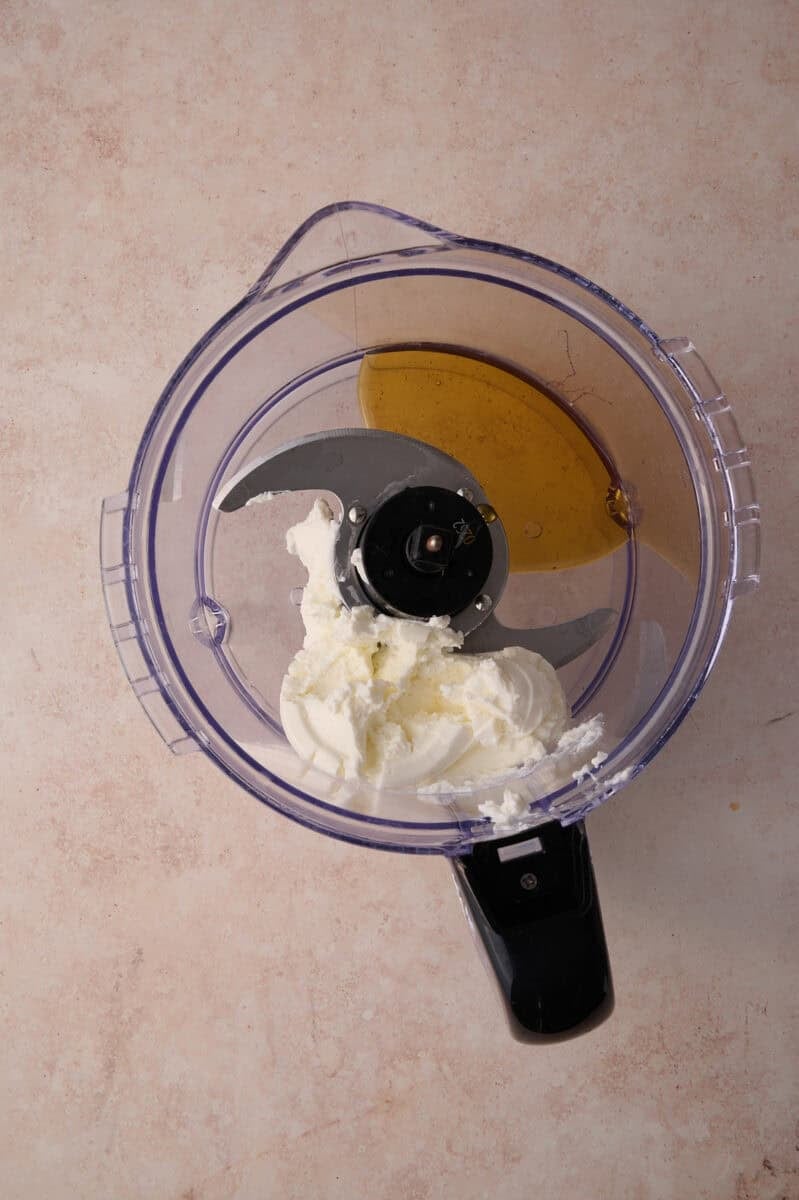 The honey and feta are added to the food processor.