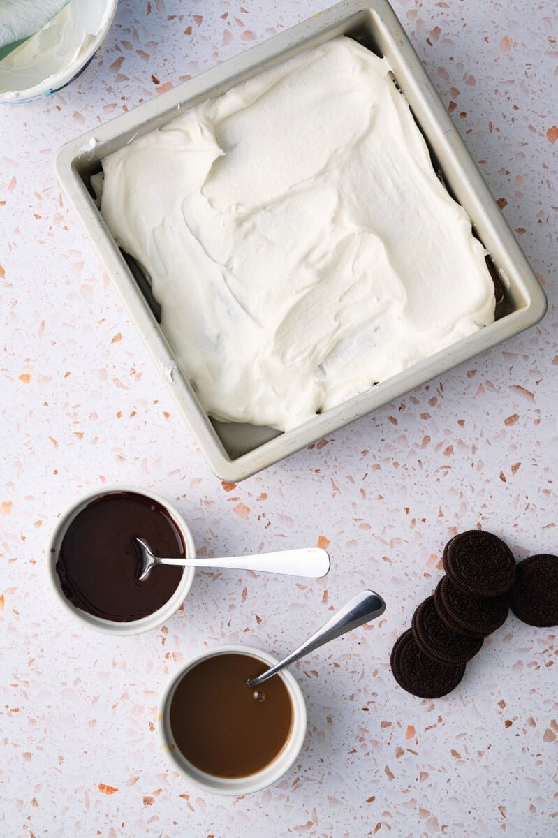 The whipped topping is added to the top of the sandwiches.