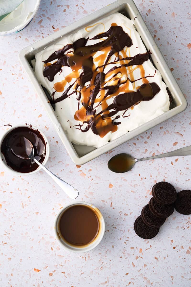 The caramel and fudge are layered on top of the whipped topping.