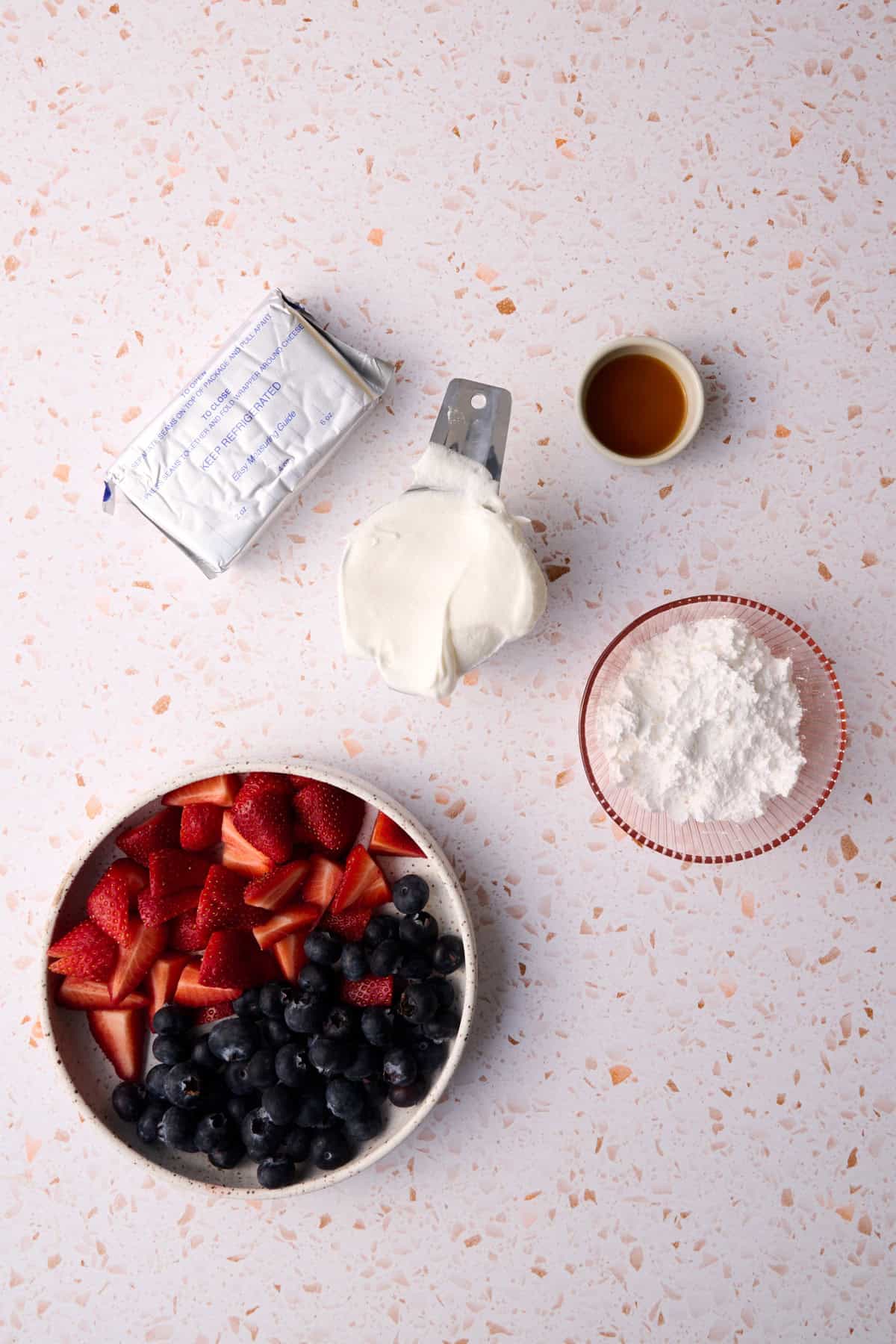 The ingredients for the cheesecake fruit salad are laid out.
