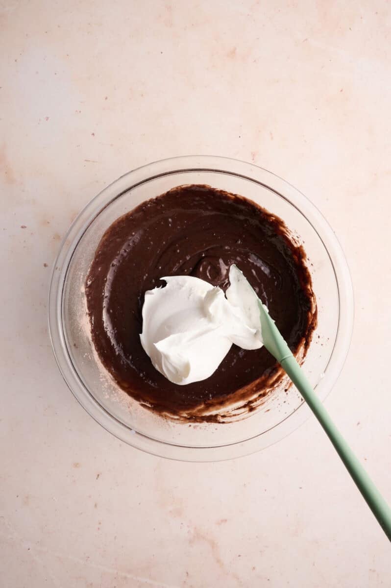 The whipped topping is being mixed into the mixing bowl.