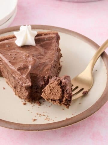 A slice of the no bake chocolate pie has a piece of the pie on a fork.