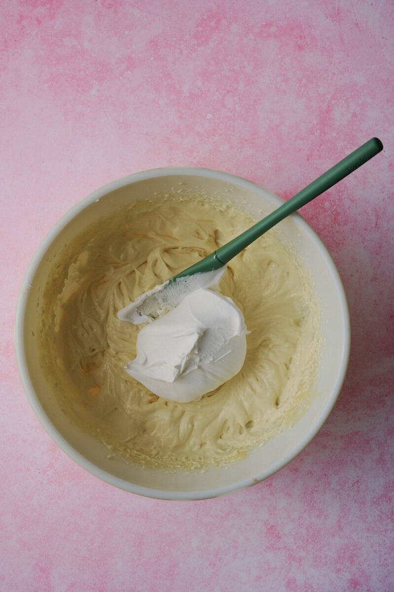 The cream cheese is added to the mixing bowl.