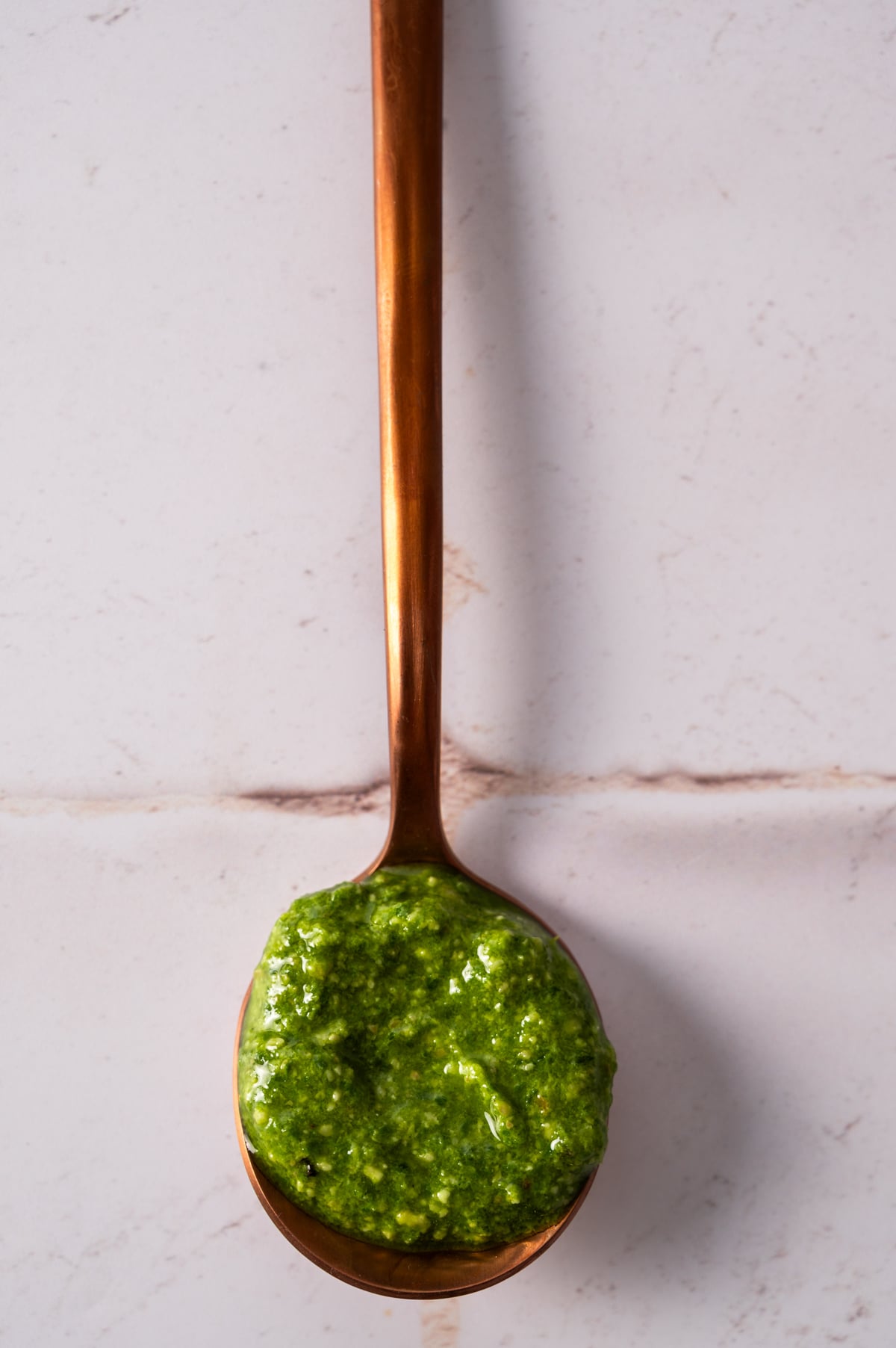 The pepita pesto is on a spoon.