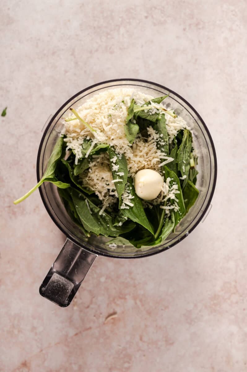 The cheese is added to the food processor. 