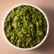 The pumpkin seed pesto is in a white bowl.