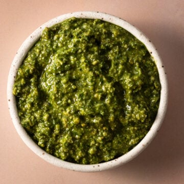The pumpkin seed pesto is in a white bowl.