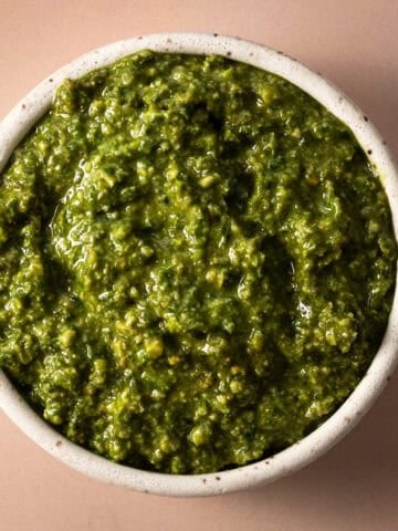 The pumpkin seed pesto is in a white bowl.
